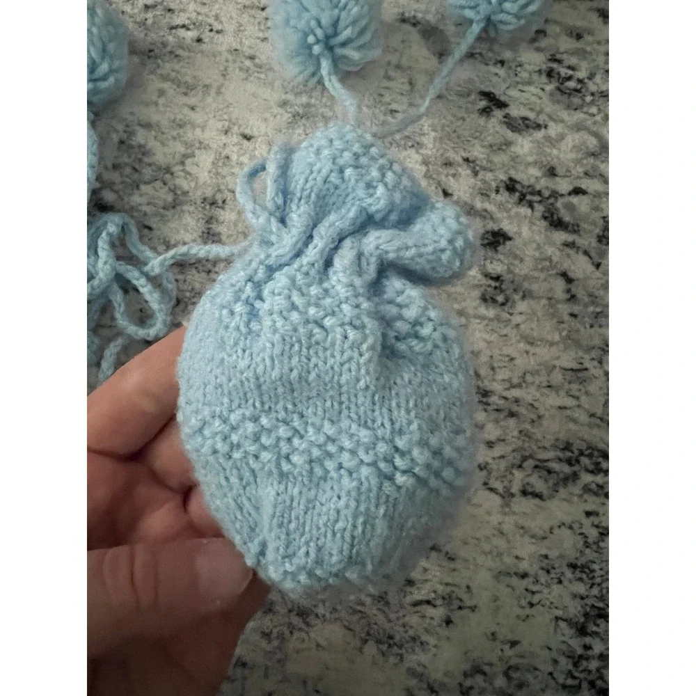 Knitted blue baby mittens and booties